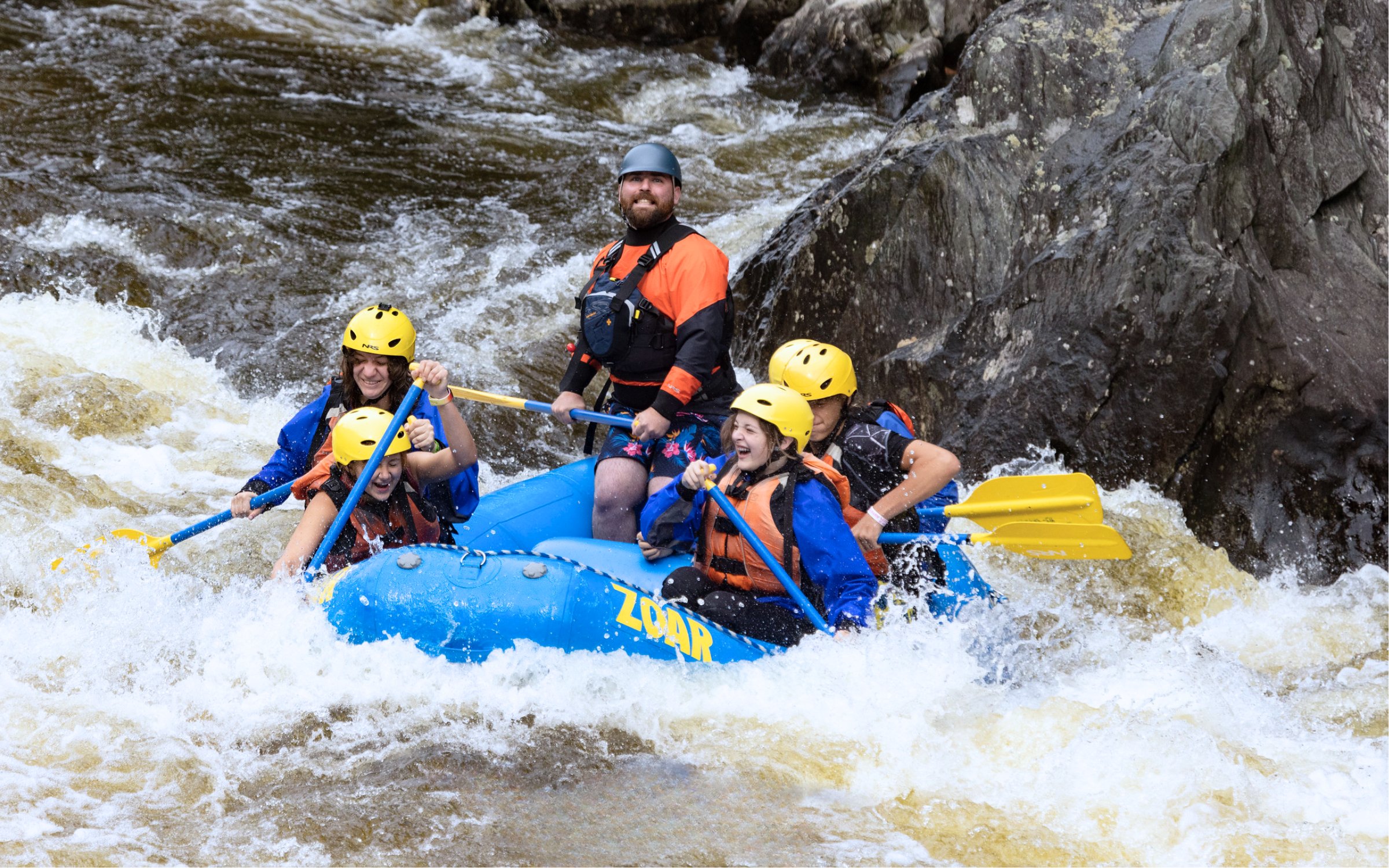 Group of rafters on whitewater adventure down Deerfield river