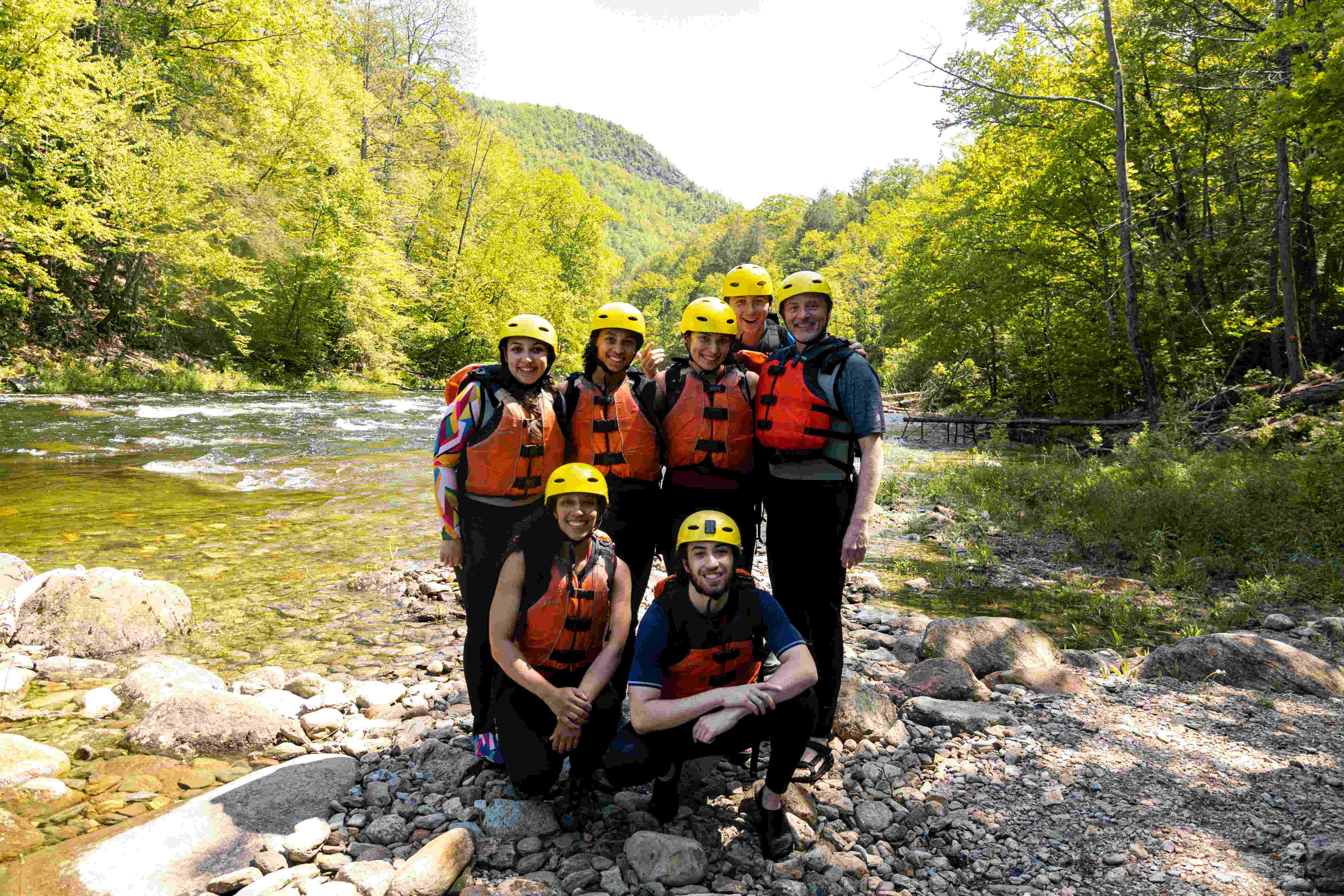 Group picture of paddlers taking a break near the river
