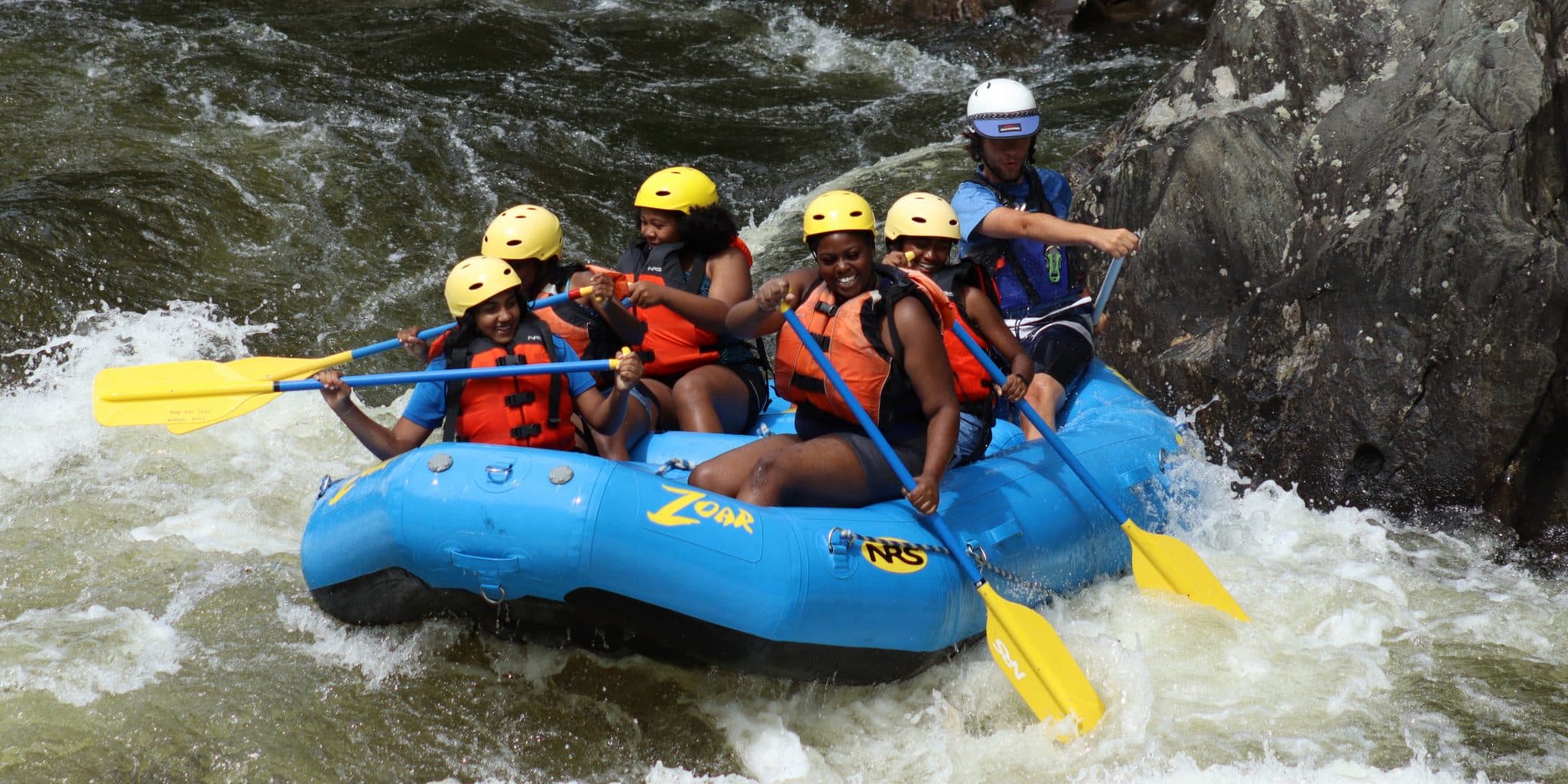 Group of youth paddlers on whitewater adventure down Deerfield river